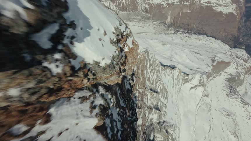 Matterhorn ridge with snow viewed from above over glacial slopes