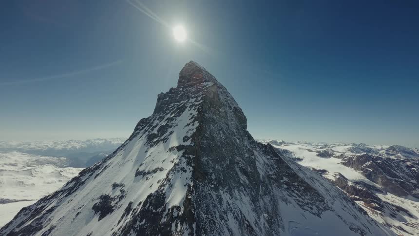 An aerial view of a mountain range covered in snow