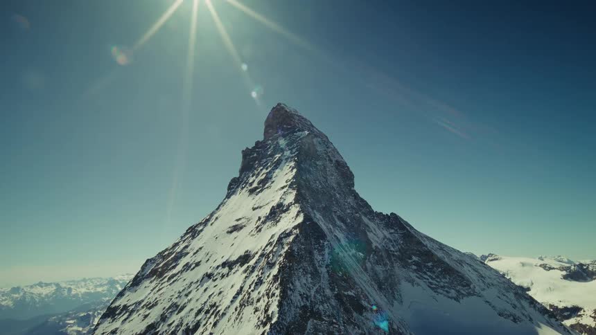 A drone shot of the Matterhorn under bright sunlight in a blue sky