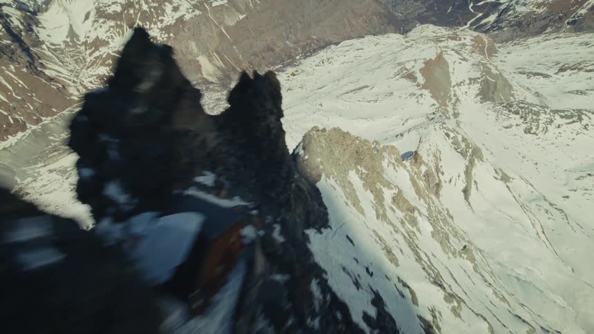 An aerial view of a mountain covered in snow