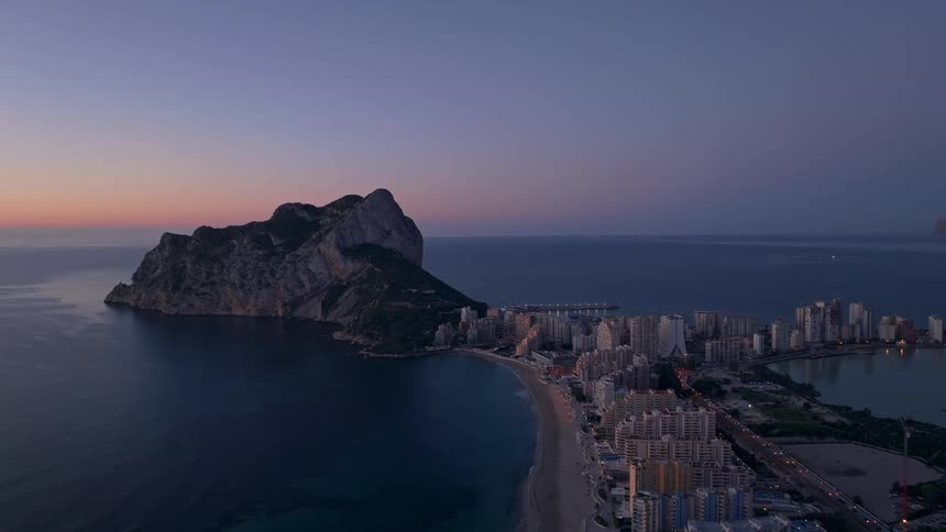 Buildings on the coast of the iberian peninsula with the rock of gibraltar overlooking the sea