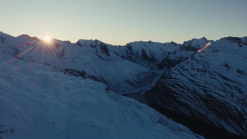 An aerial view of a mountain range covered in snow