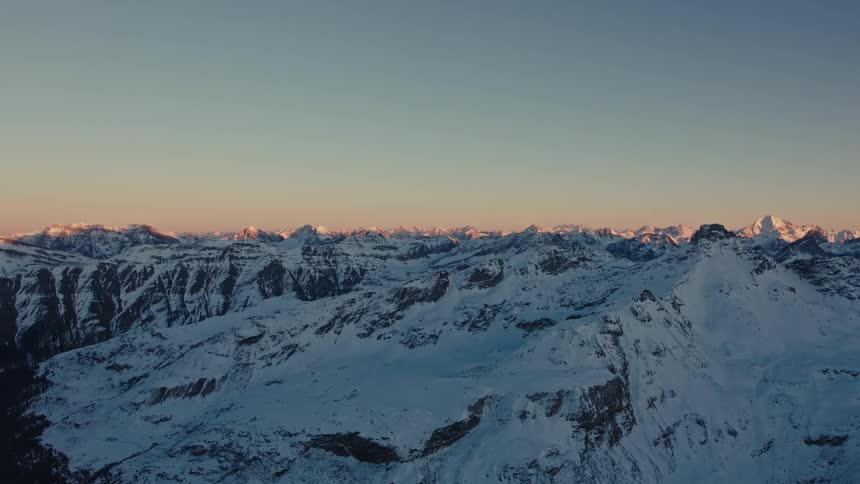 Snow covered rough rocky mountain terrain across the landscape