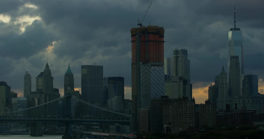City skyscrapers sit beneath a cloudy sky