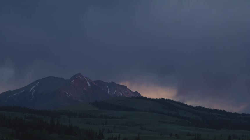 A view of a landscape with a mountain in the distance