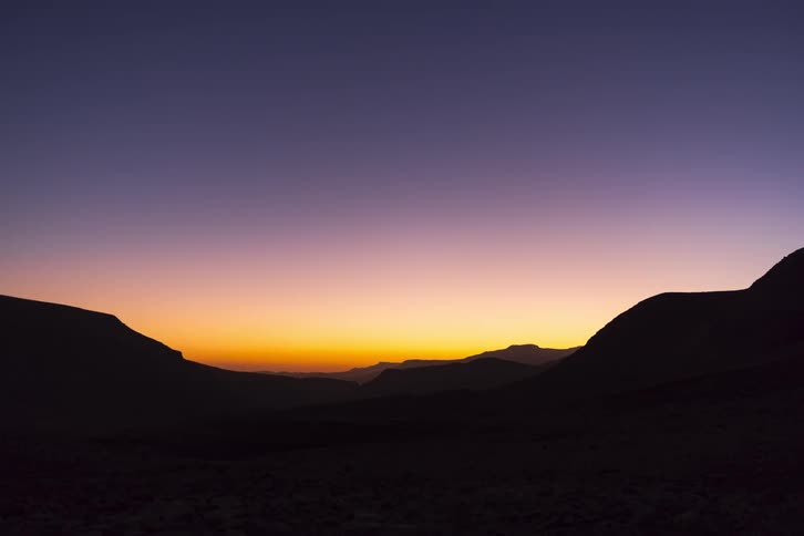 Silhouette of mountains across the landscape at dusk