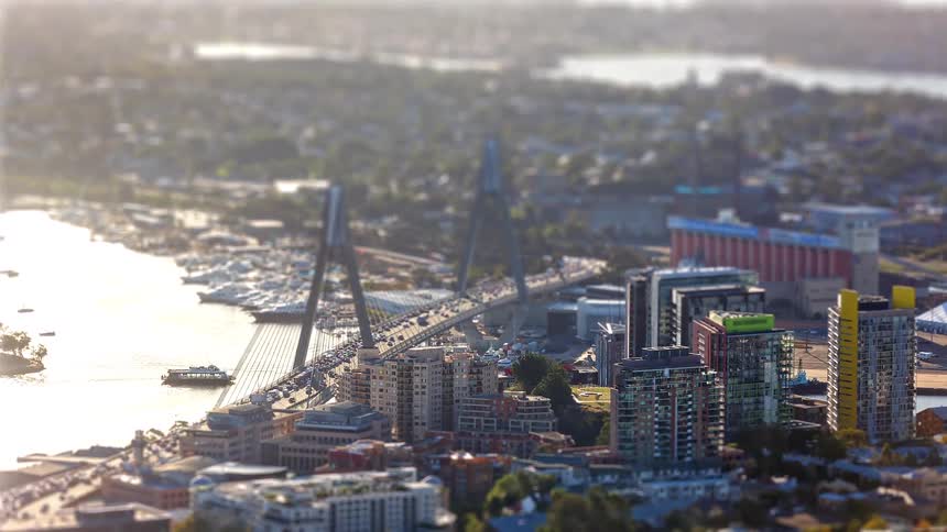 Heavy traffic moves across a bridge out of the city