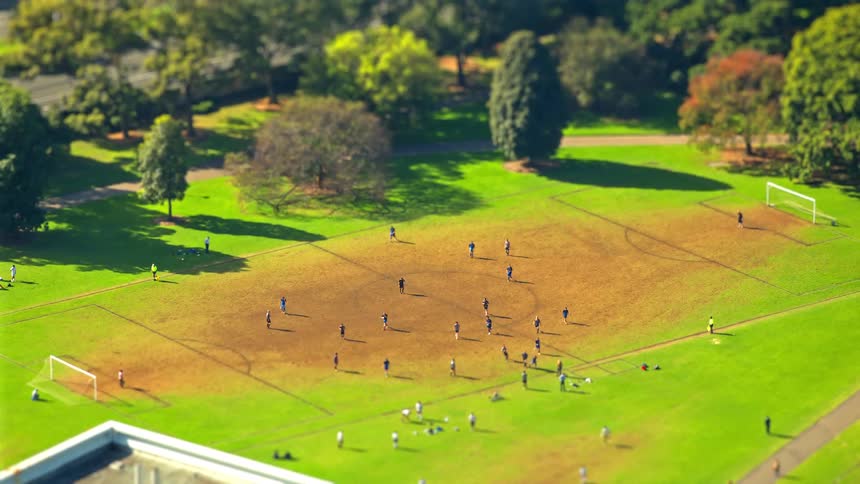 A bunch of men are on a soccer field playing a game