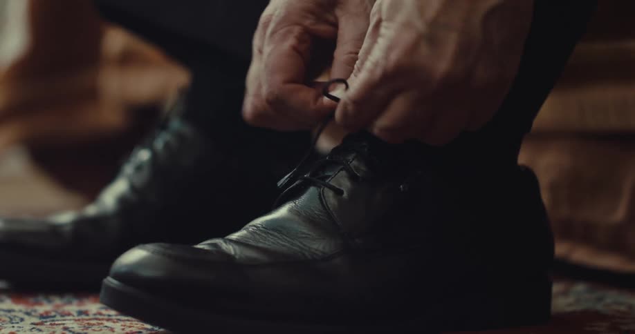 Man ties the laces of his shoes