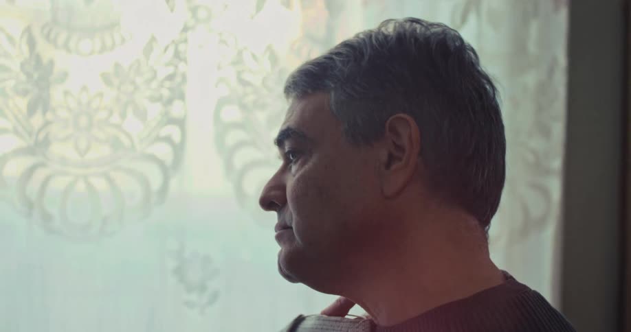 A man in a room looking at jackets