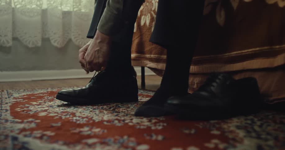 A man tying shoes