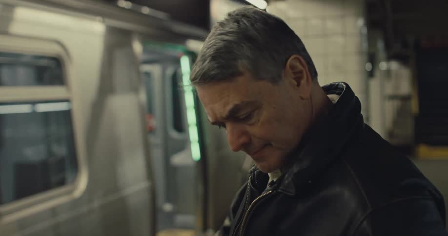 A man standing at a subway station