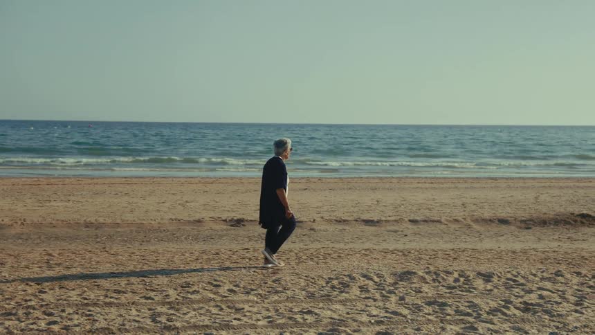 A woman walking on a beach