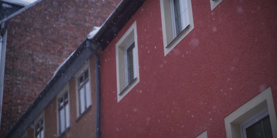 A building with snow falling in front of it