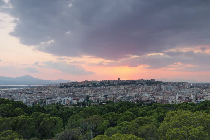 City view with lights at dusk under cloudy sky
