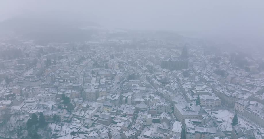 An aerial view of a city covered in snow