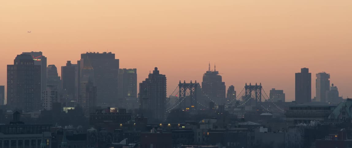 The sun sets in a city