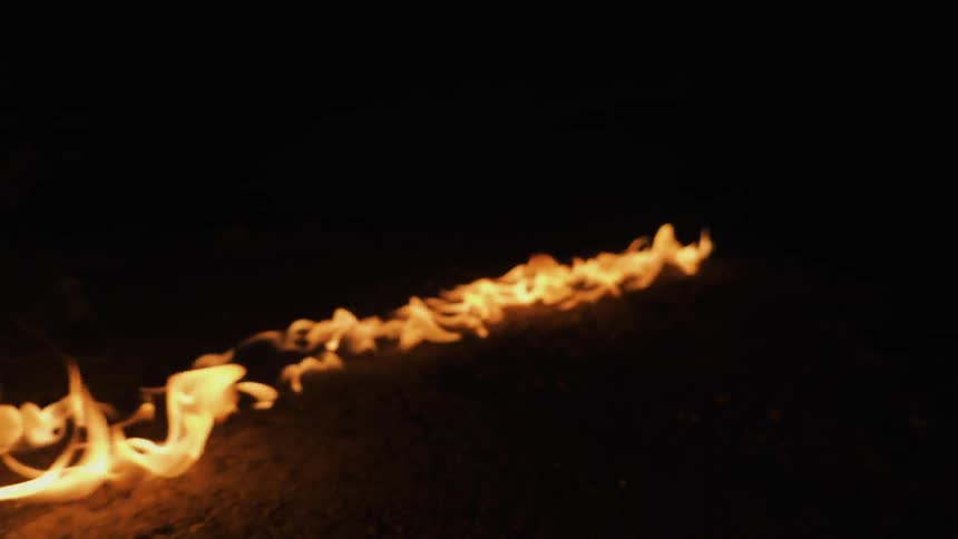 A fire burns in a straight line on the ground