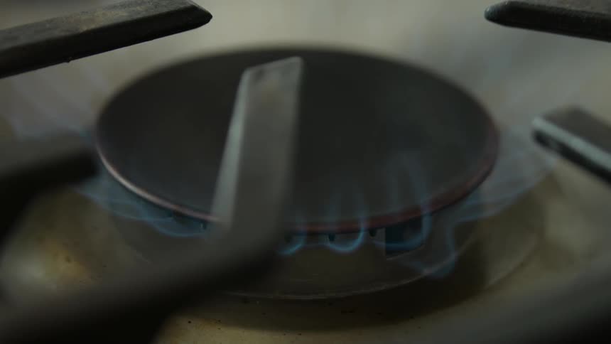 Flames emerge from a stove burner