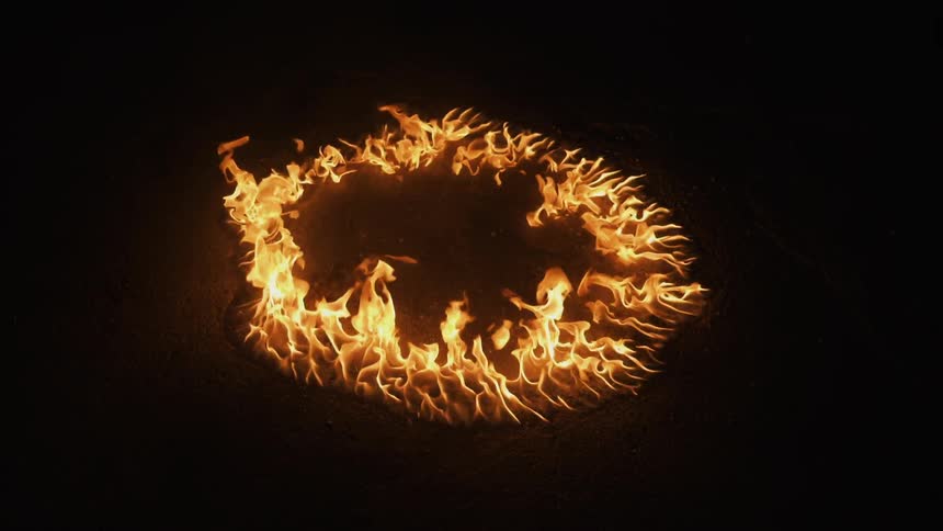 Flames form a circle in the dark
