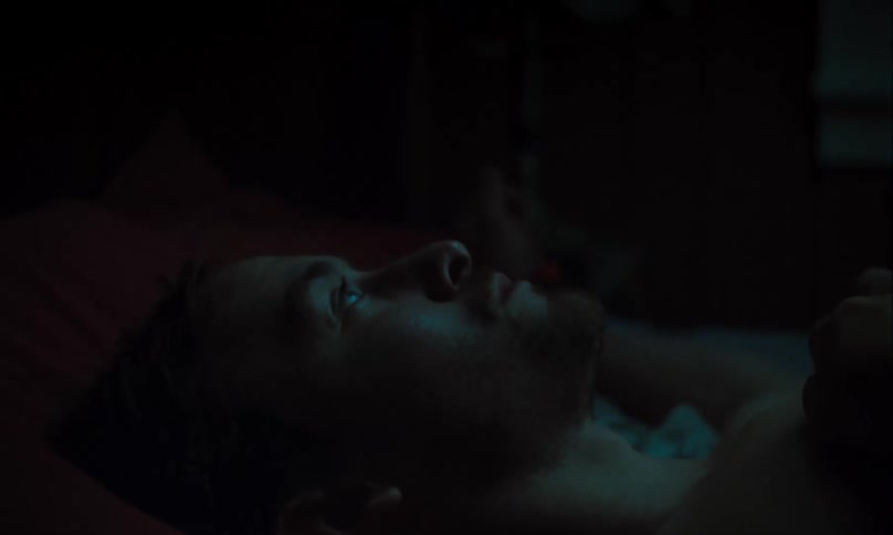 An anxious man struggles to fall asleep
