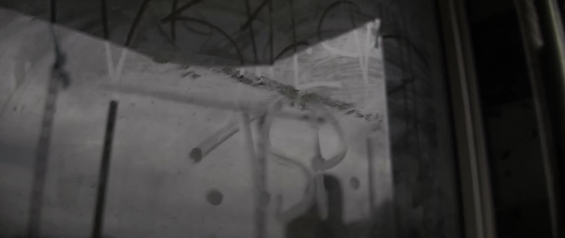 A dirty window is covered with writing