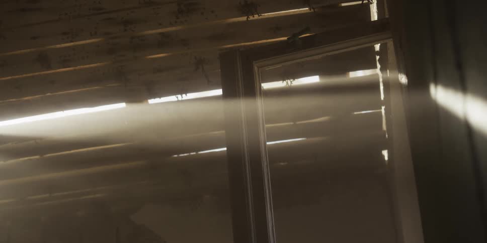 Golden sunbeams cut through the dusty air of an old abandoned attic, illuminating floating particles