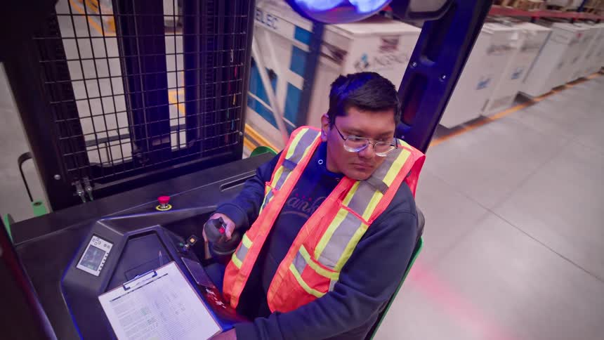 Time-lapse POV of a forklift operator driving through the aisles of a warehouse