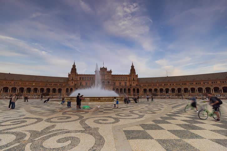 A captivating day-to-night time-lapse of the magnificent Plaza de España in Seville, Spain, as tourists bustle around the grand fountain and iconic architecture