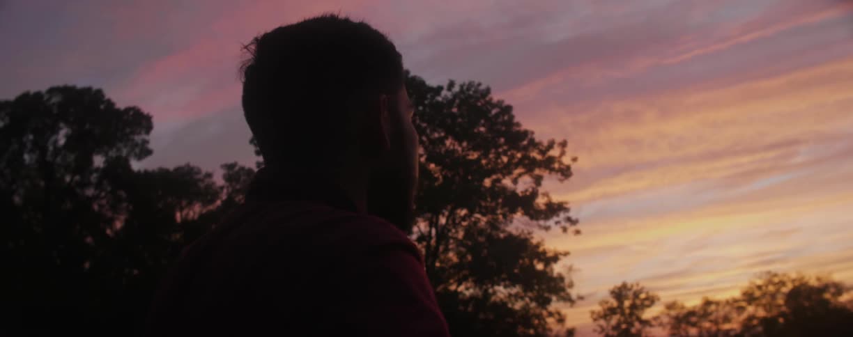A man look up at a sunset