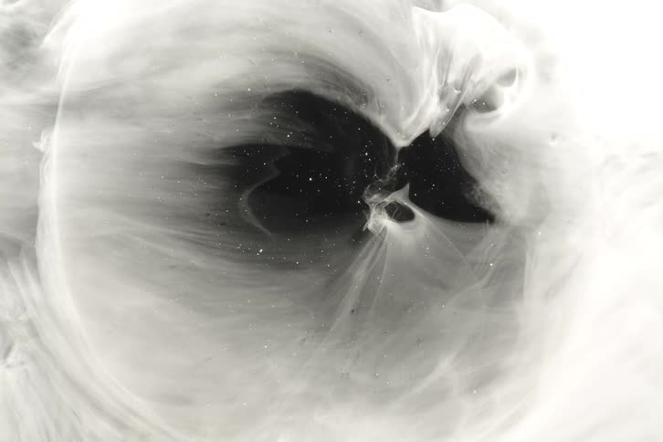 Ethereal white smoke swirls around a dark, star-filled void in a mesmerizing abstract display