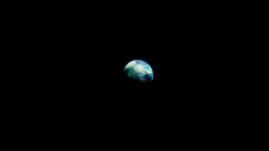 A majestic, slow zoom towards the vibrant Planet Earth, revealing its detailed surface from the vast emptiness of space