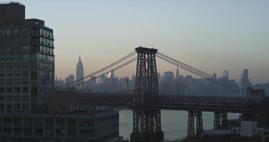 A large bridge with buildings around it and a city in the background