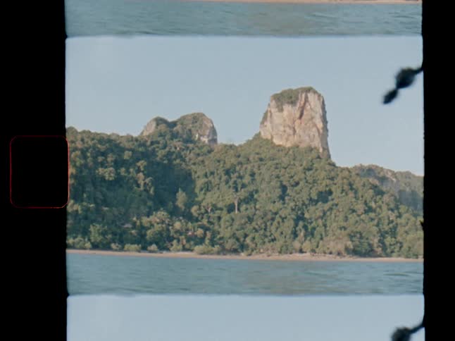 An authentic film scan shows a view of a lush green tropical island with unique rock formations