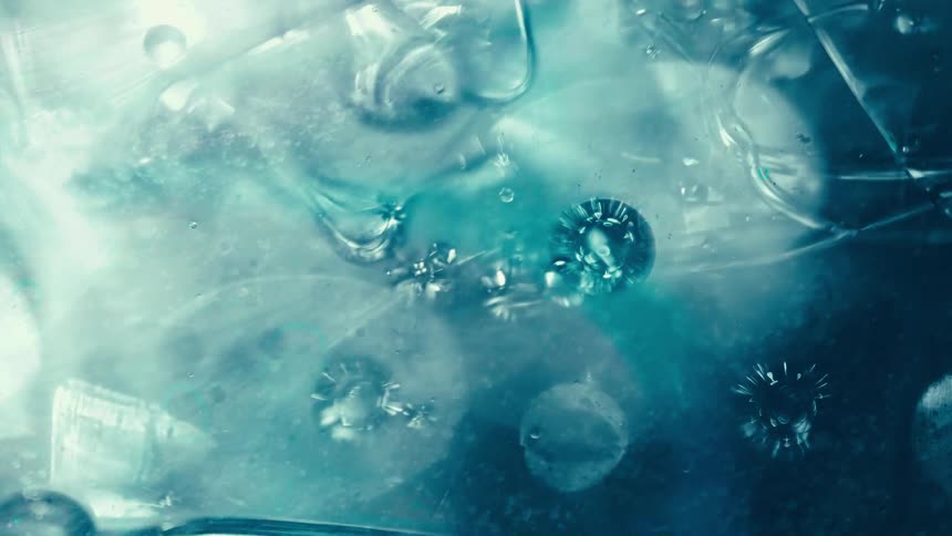 A surreal, microscopic view of spiky virus-like orbs and bubbles slowly moving through an ethereal blue liquid
