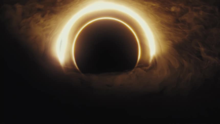 A mesmerizing animation shows a cosmic black hole with a bright, glowing golden ring surrounded by swirling gas clouds