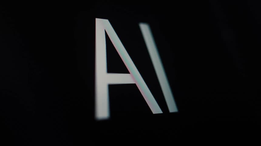 Close-up macro shot of the letters AI for Artificial Intelligence appearing on a dark digital screen