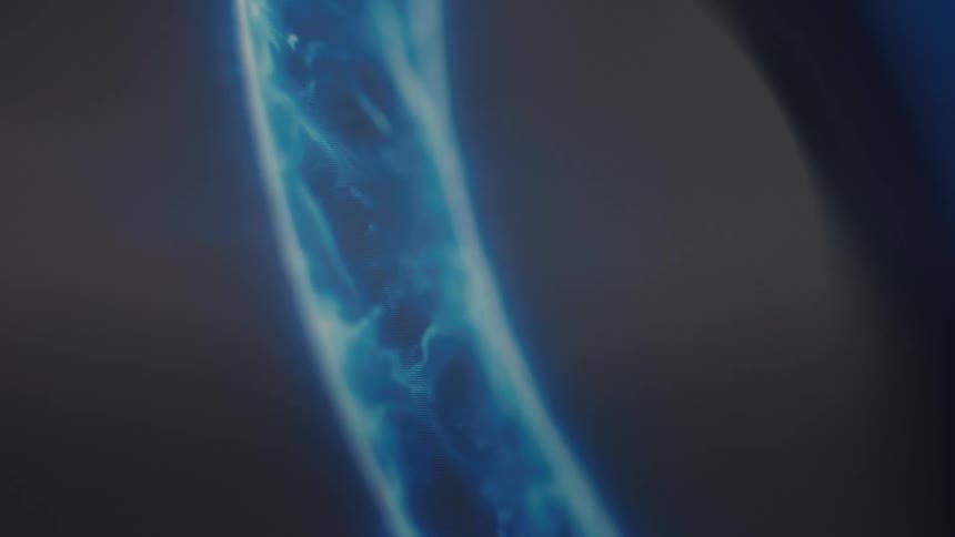 A mesmerizing close-up of a vibrant blue, plasma-like energy field with flowing patterns against a dark background