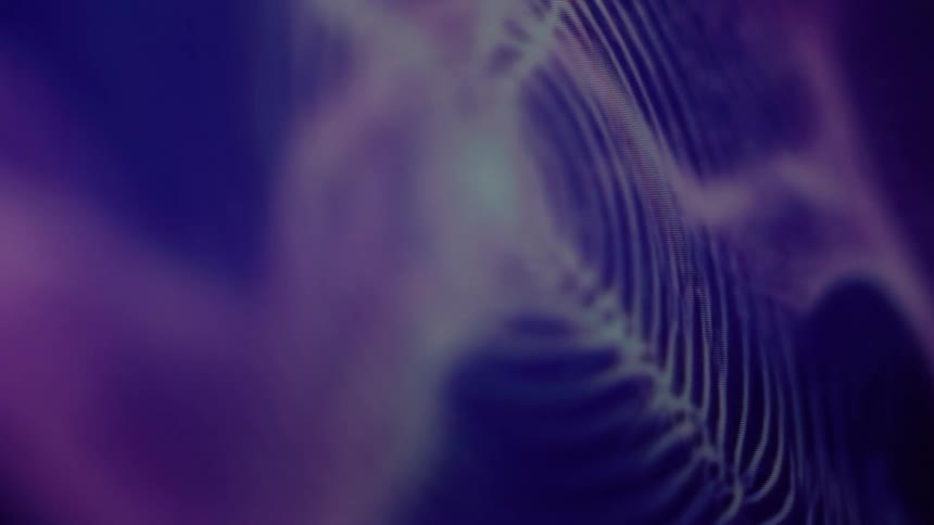 An ethereal and blurry abstract background with slowly moving waves of purple and blue light