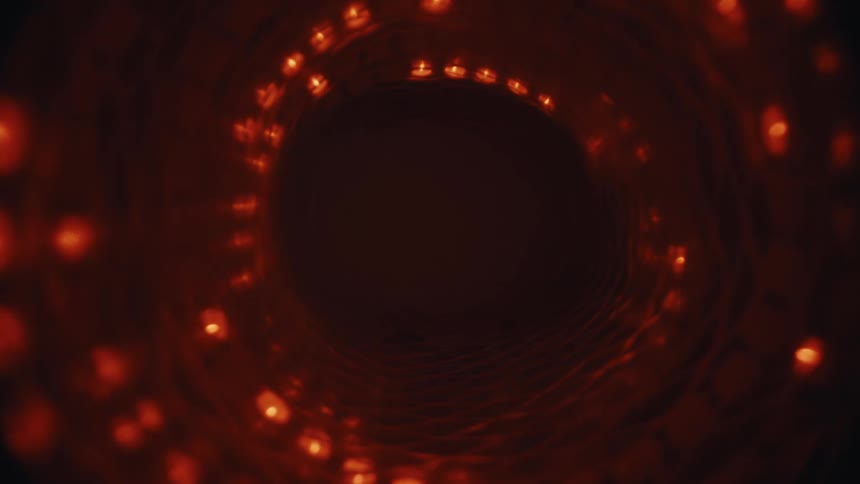 An abstract journey through a dark, rotating vortex lined with spiraling red lights that slowly fade to black