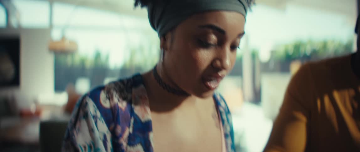 Slow motion shot of a young couple happily collaborating on their finances, using a calculator to review their budget at home