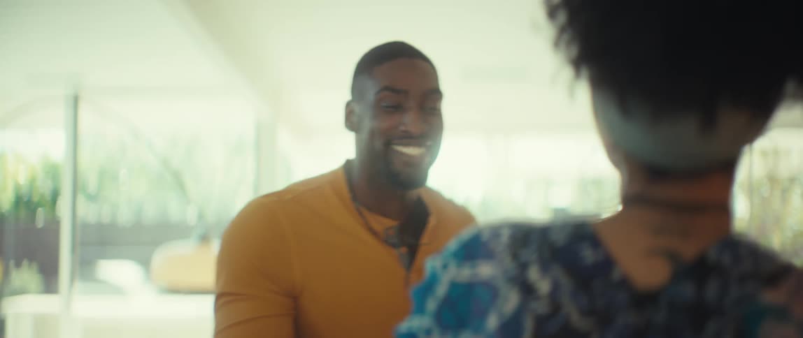 Joyful couple dances in slow motion in their sun-drenched living room