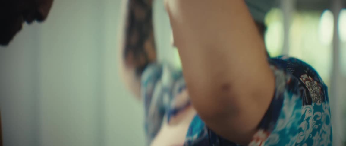 A stylish young Black couple shares an intimate and joyful slow dance in their sunlit home