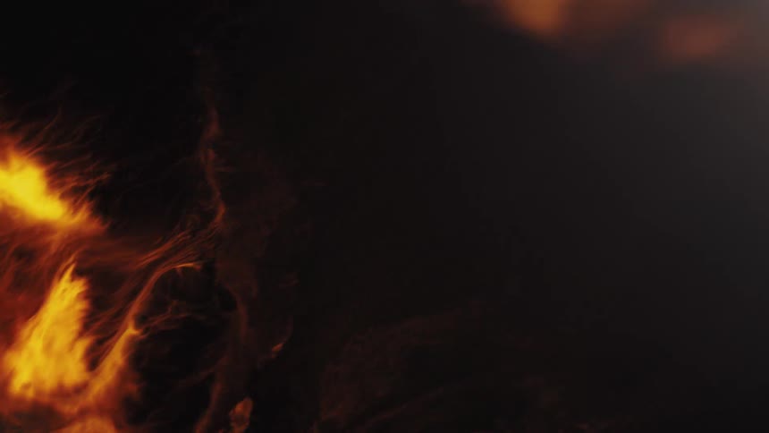 An abstract burst of fiery, golden smoke swirls and expands before completely dissipating into darkness