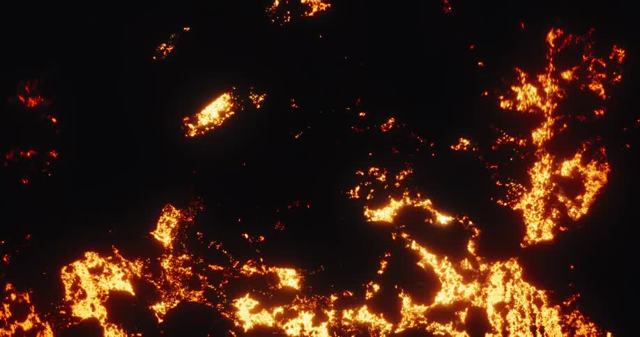 An overhead aerial view slowly reveals a vast, glowing field of molten lava flowing at night