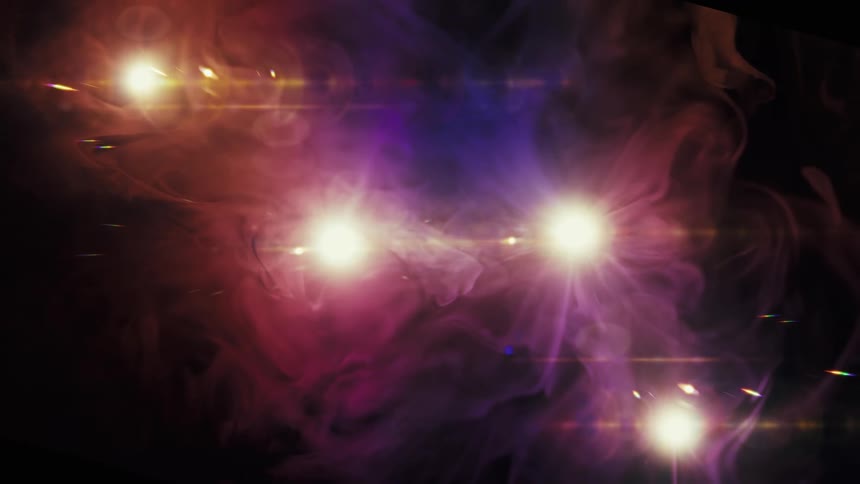 Glowing celestial lights shine through a nebula of colorful smoke in this abstract motion background