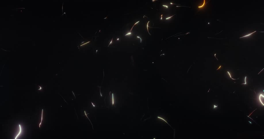 An abstract animation of colorful glowing lines and particles moving randomly against a dark background