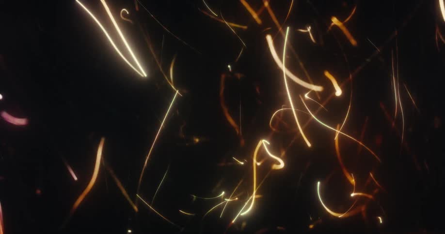 An abstract animation of colorful glowing light streaks and particles dancing dynamically on a black background