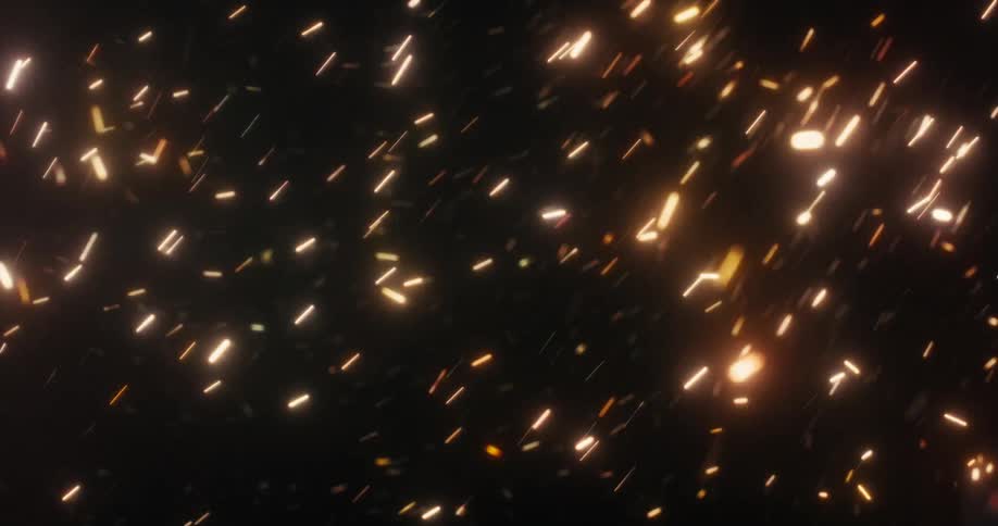 A dynamic animation of glowing golden sparks and embers flying and swirling chaotically against a dark background