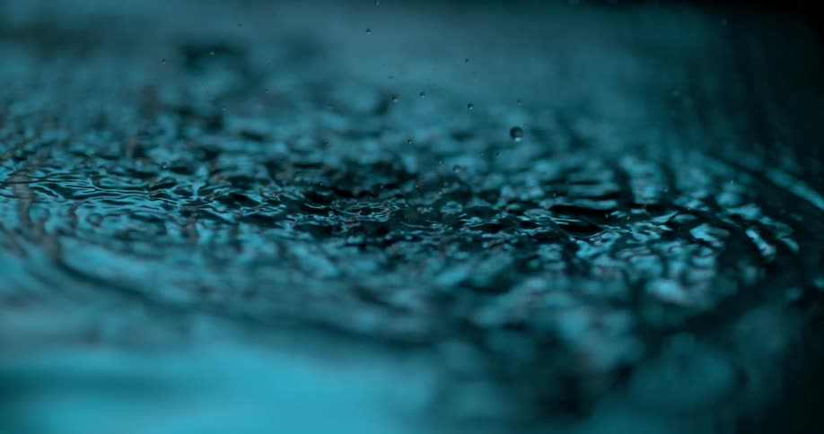 A bullet falls in the water splashing